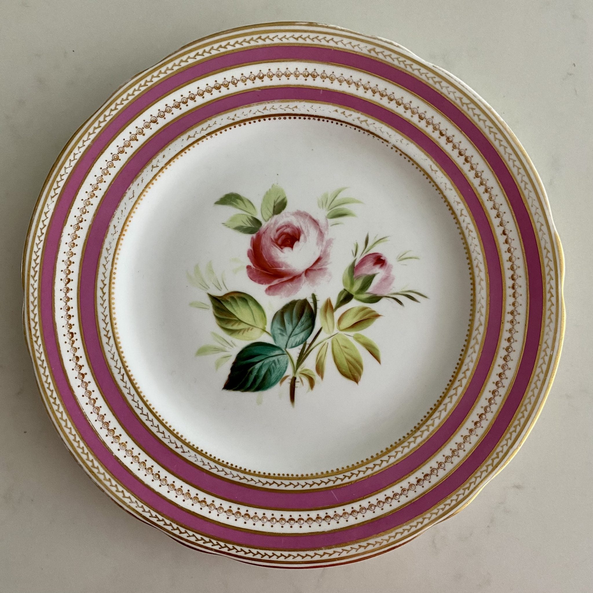 K96 SET 11 ANTIQUE PINK & GILT RIMMED HAND PAINTED FLOWER PLATES